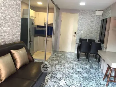 Modern apartment interior with stylish living room and kitchen, featuring elegant decor and open layout.