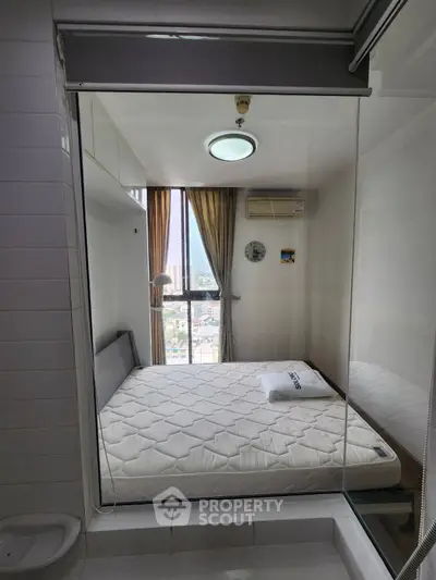 Modern compact bedroom with large window and city view