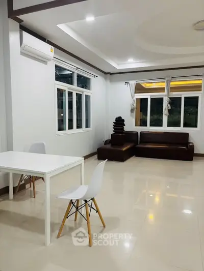Spacious modern living room with sleek furniture and large windows