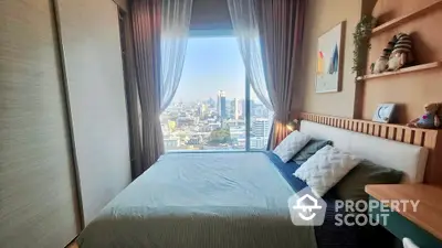 Cozy bedroom with a stunning cityscape view through a large window, offering a serene urban retreat in a high-rise apartment.