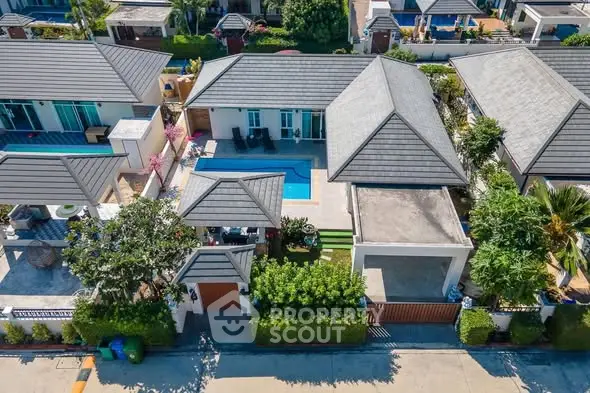 Aerial view of luxurious villa with private pool and lush garden