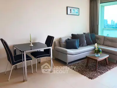 Modern living room with city view, stylish furniture, and cozy decor.