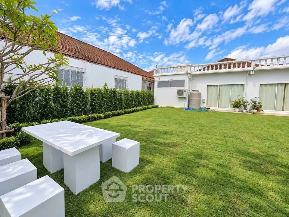 Spacious garden with modern outdoor seating in a luxurious property