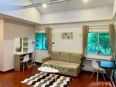 Spacious living room with modern decor and large windows offering natural light.