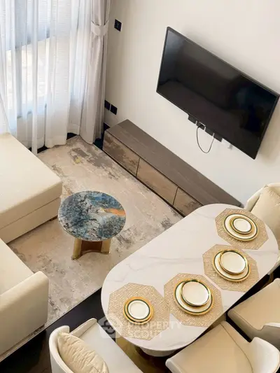 Elegant living room with modern decor, featuring a cozy seating area and stylish dining setup.