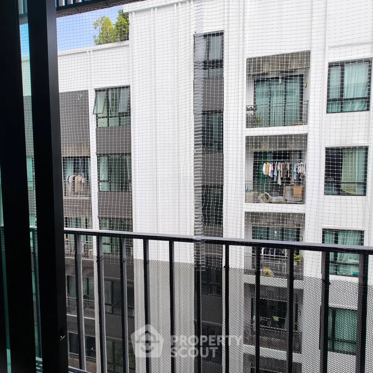 Modern apartment building view from balcony with safety netting