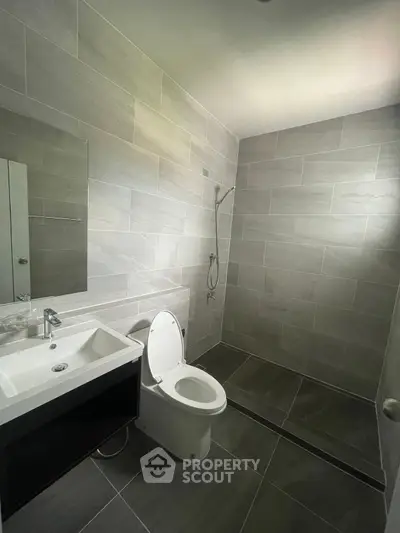 Modern bathroom with sleek tiles and open shower design