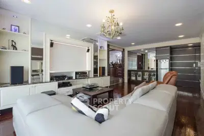 Luxurious living room with elegant chandelier and modern entertainment setup
