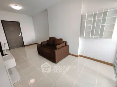 Modern minimalist living room with brown sofa and white shelving unit.