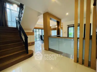 Spacious modern interior with elegant staircase and open layout, perfect for stylish living.