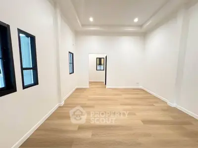 Spacious modern living room with wooden flooring and recessed lighting