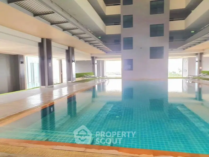 Luxurious indoor pool area with modern design and ample natural light