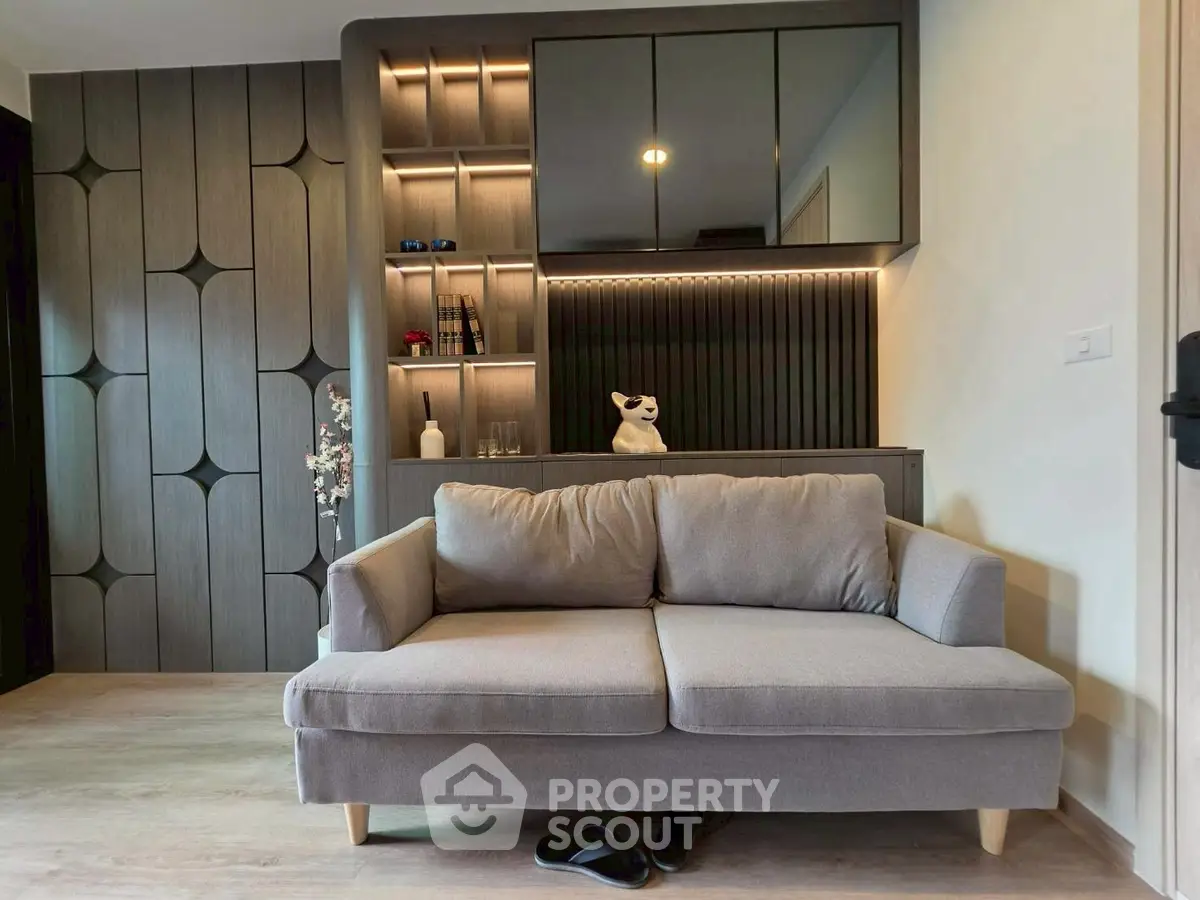 Modern living room with stylish sofa and built-in shelving