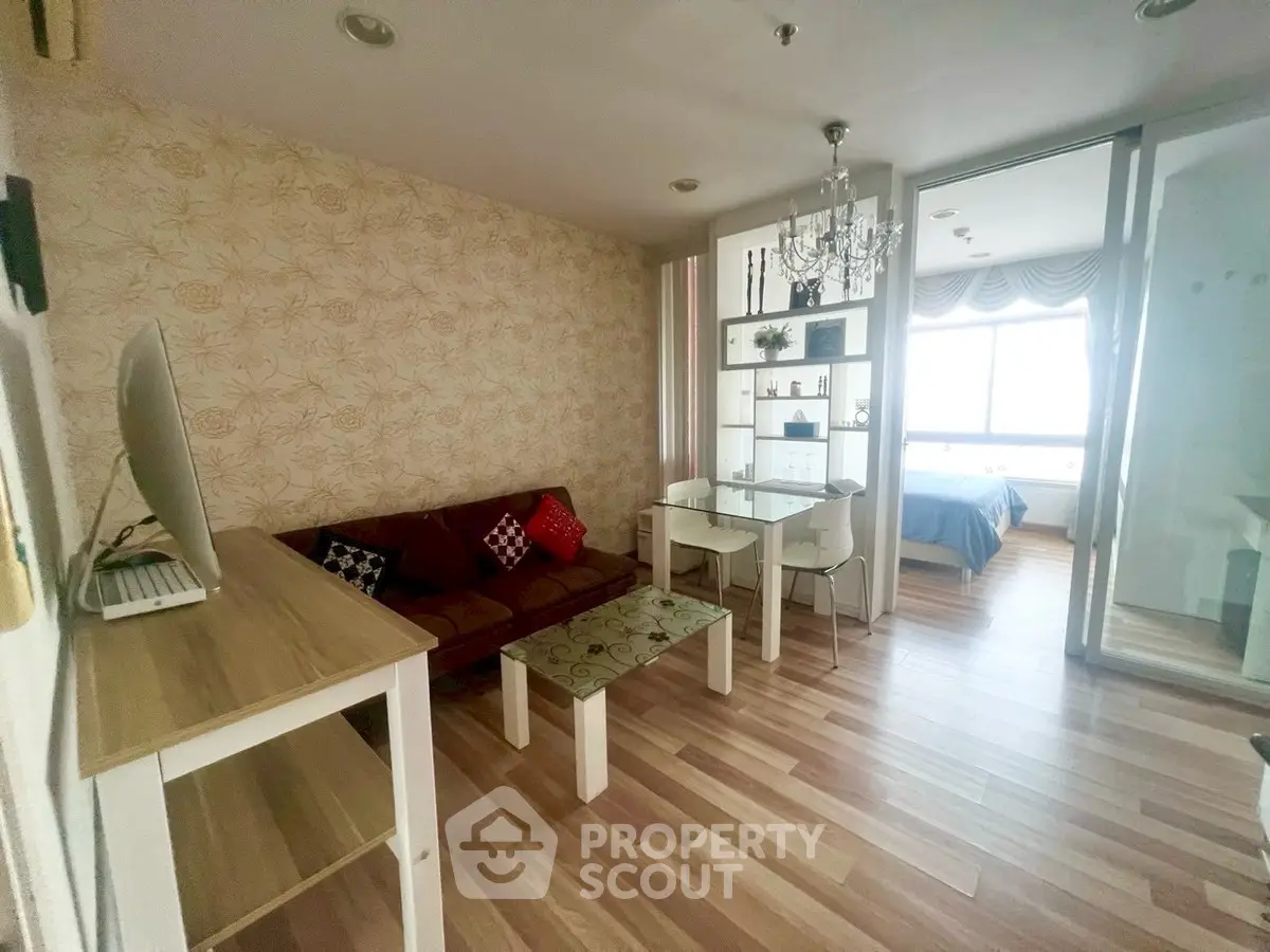 Charming living room with elegant decor and adjacent bedroom view