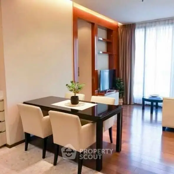 Elegant dining area with modern furniture and natural light in a stylish apartment.