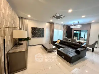 Luxurious modern living room with elegant decor and spacious seating area.