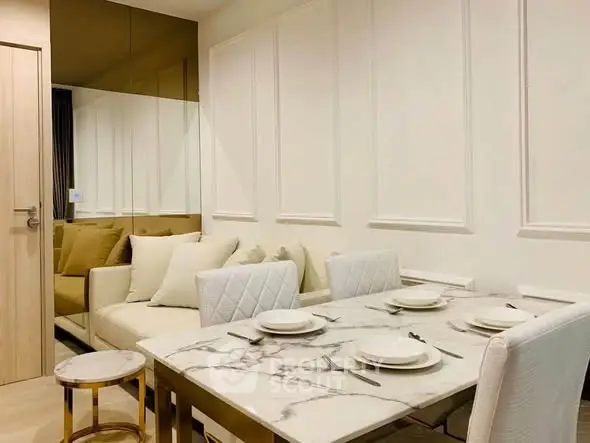 Elegant dining area with marble table and cozy seating in modern apartment