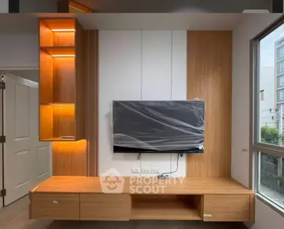 Modern living room with sleek wooden TV unit and ambient lighting