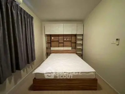 Cozy bedroom with modern wooden bed frame and built-in storage, perfect for a minimalist lifestyle.
