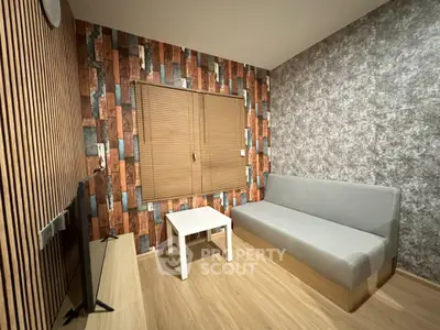Modern living room with stylish wallpaper and cozy seating area
