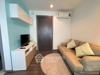 Cozy living room with modern decor and air conditioning, perfect for relaxation.