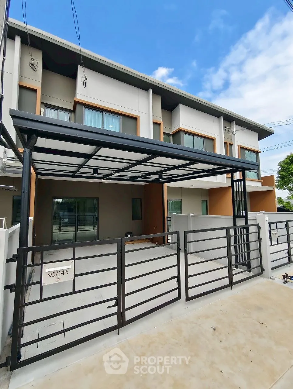 Modern townhouse with sleek design and spacious driveway in a serene neighborhood.