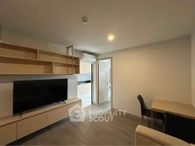 Modern living room with sleek furniture and open kitchen layout