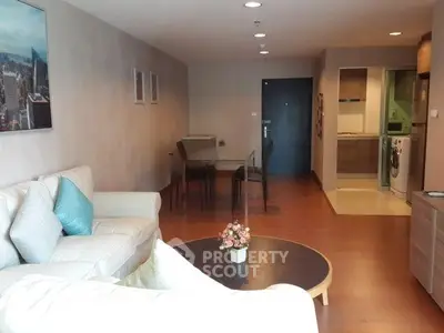Spacious living room with modern decor and dining area in open layout apartment.