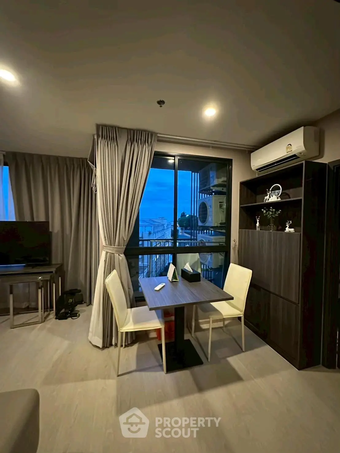 Modern living room with dining area and balcony view in stylish apartment