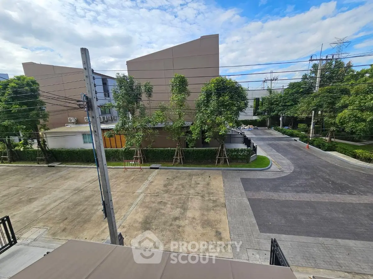 Spacious residential area with lush greenery and modern buildings