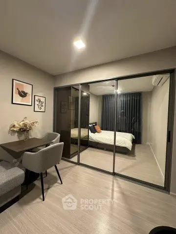 Modern apartment with glass partitioned bedroom and stylish dining area.