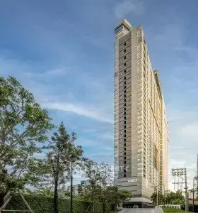 Stunning high-rise building with modern architecture and lush greenery, perfect for urban living.