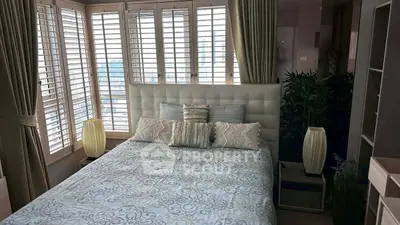 Elegant bedroom with large windows and stylish decor