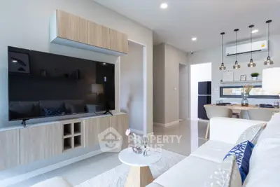 Modern living room with sleek furniture and open dining area, perfect for contemporary living.