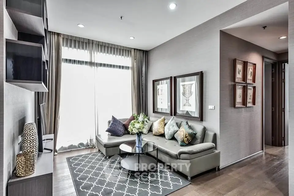 Modern living room with stylish decor, large windows, and cozy seating area.