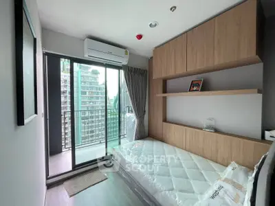 Modern bedroom with balcony view in high-rise apartment, featuring sleek design and ample natural light.