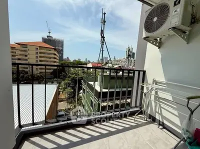 Charming balcony with city view and air conditioning unit, perfect for relaxation.