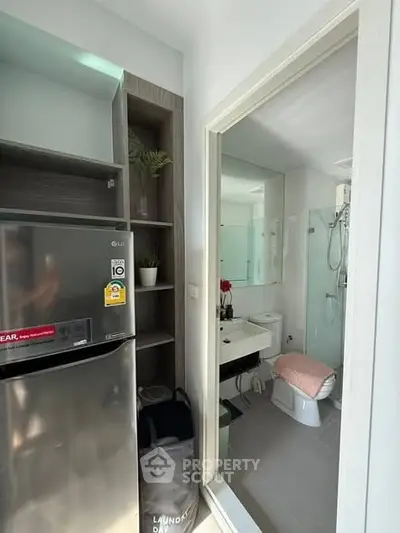 Modern compact apartment with sleek kitchen and stylish bathroom, perfect for urban living.