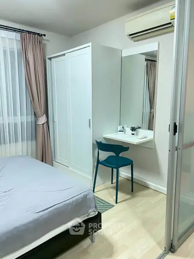 Cozy bedroom with modern furniture, featuring a sleek wardrobe and stylish desk area.