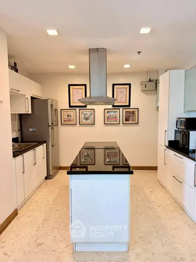 Modern kitchen with sleek island and stainless steel appliances, perfect for culinary enthusiasts.