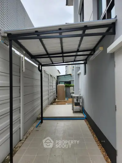 Modern exterior side passage with covered walkway and utility area