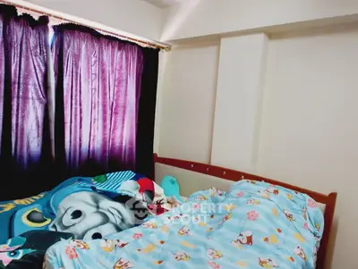 Cozy bedroom with colorful bedding and dark curtains, perfect for a restful night's sleep.