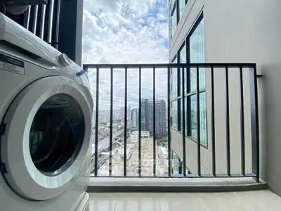 Modern high-rise balcony with city view and washing machine