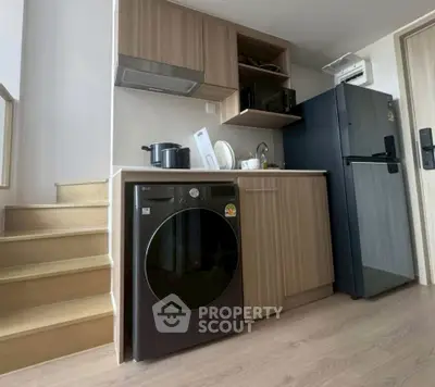 Modern compact kitchen with washing machine and sleek appliances