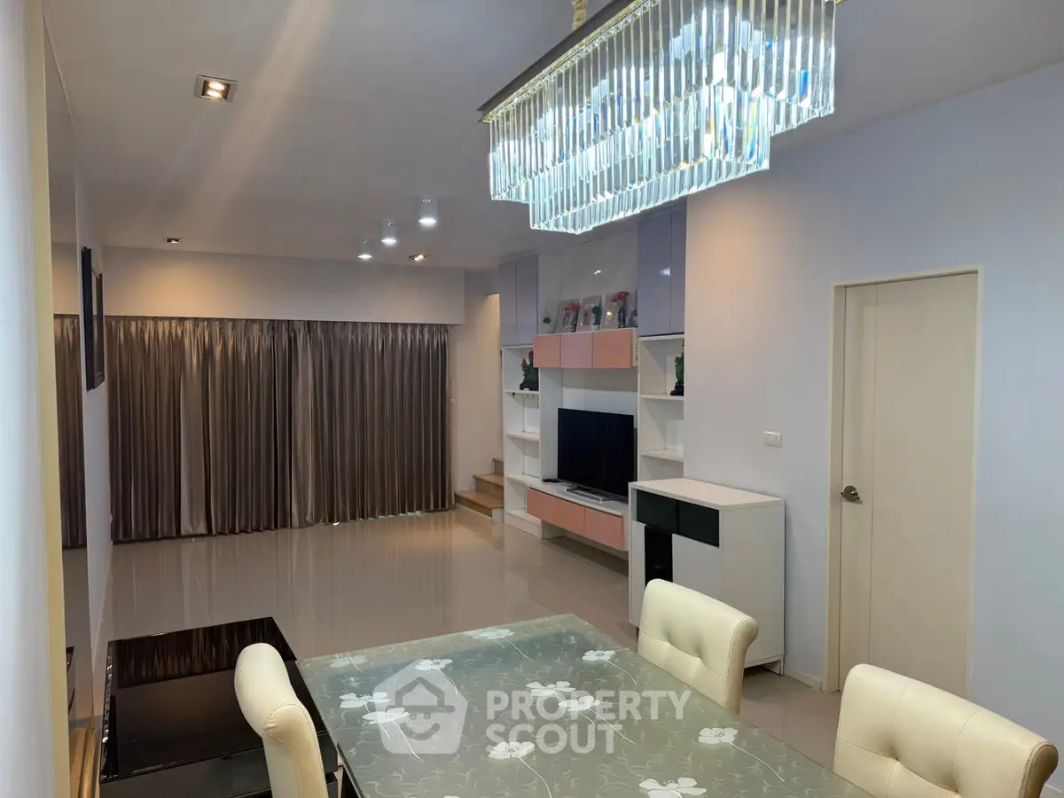 Spacious modern living room with elegant chandelier and stylish decor