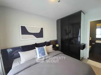 Modern bedroom with sleek black wardrobe and stylish decor