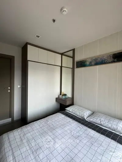 Modern bedroom with stylish decor and ample storage space