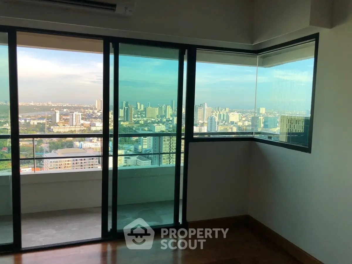 Stunning high-rise apartment with panoramic city views and floor-to-ceiling windows.