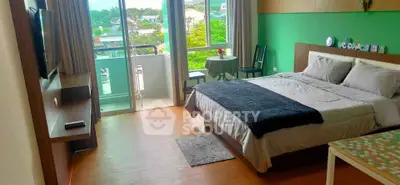 Spacious bedroom with balcony and scenic view in modern apartment