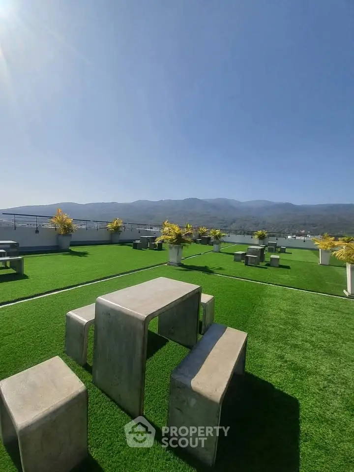 Stunning rooftop terrace with modern seating and panoramic mountain views.